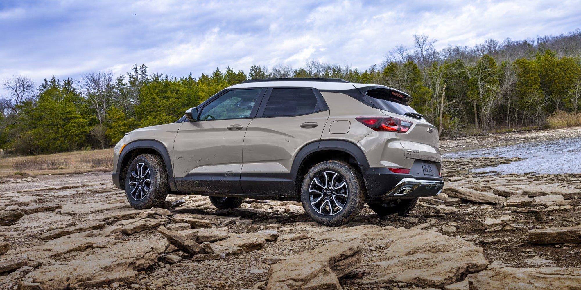 2026 Chevrolet Trailblazer rear three-quarter view on rocky terrain by water